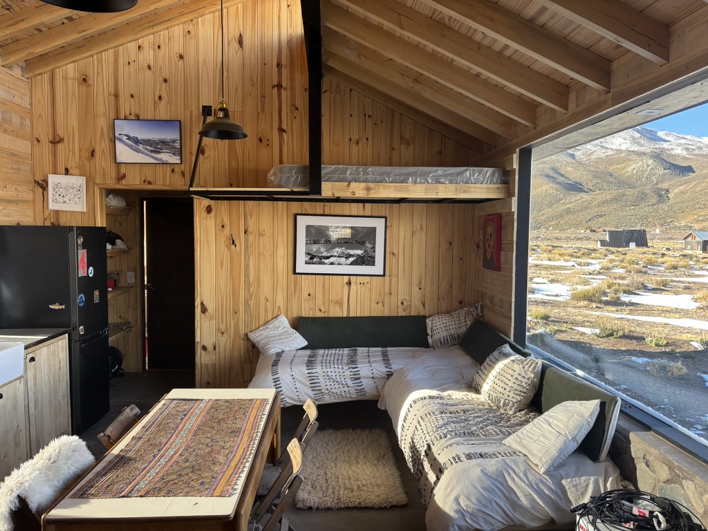 Cozy custom wood-paneled cabin interior with mountain views